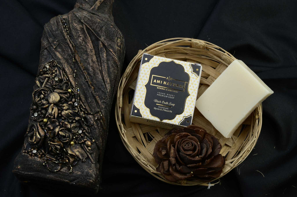 AMI NATURAL BLACK OUDH SOAP pack of 6 with elegant black and gold packaging and a white soap bar in a woven basket