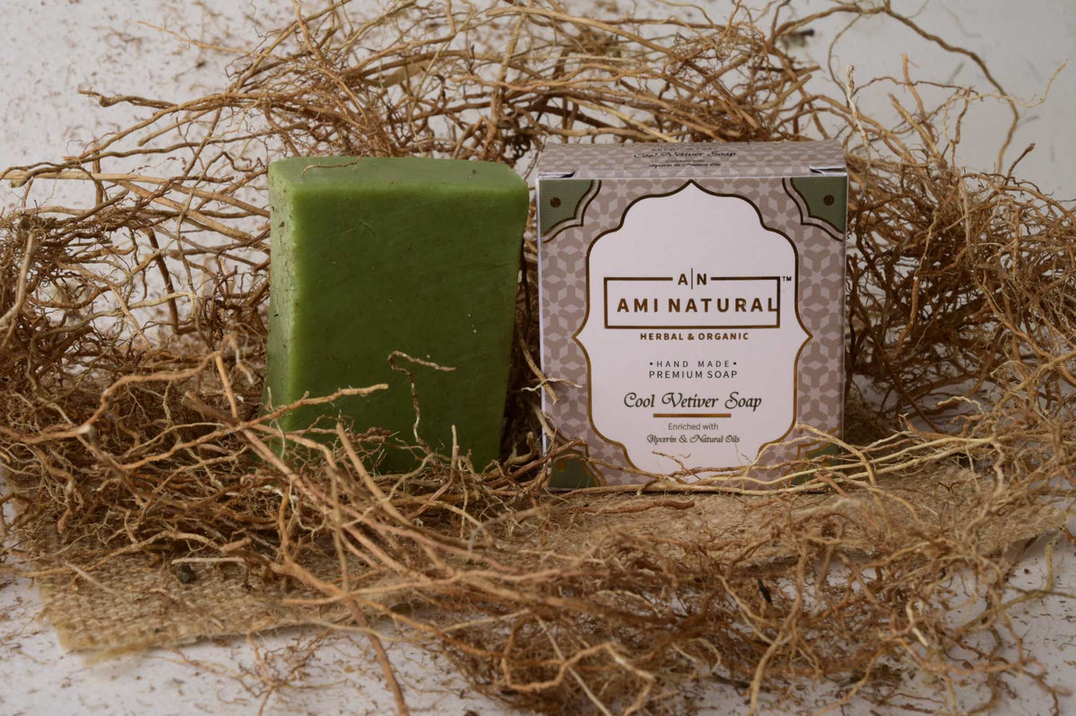 AMI NATURAL COOL VETIVAR SOAP green herbal soap bar with its beige and green packaging surrounded by dried vetiver roots