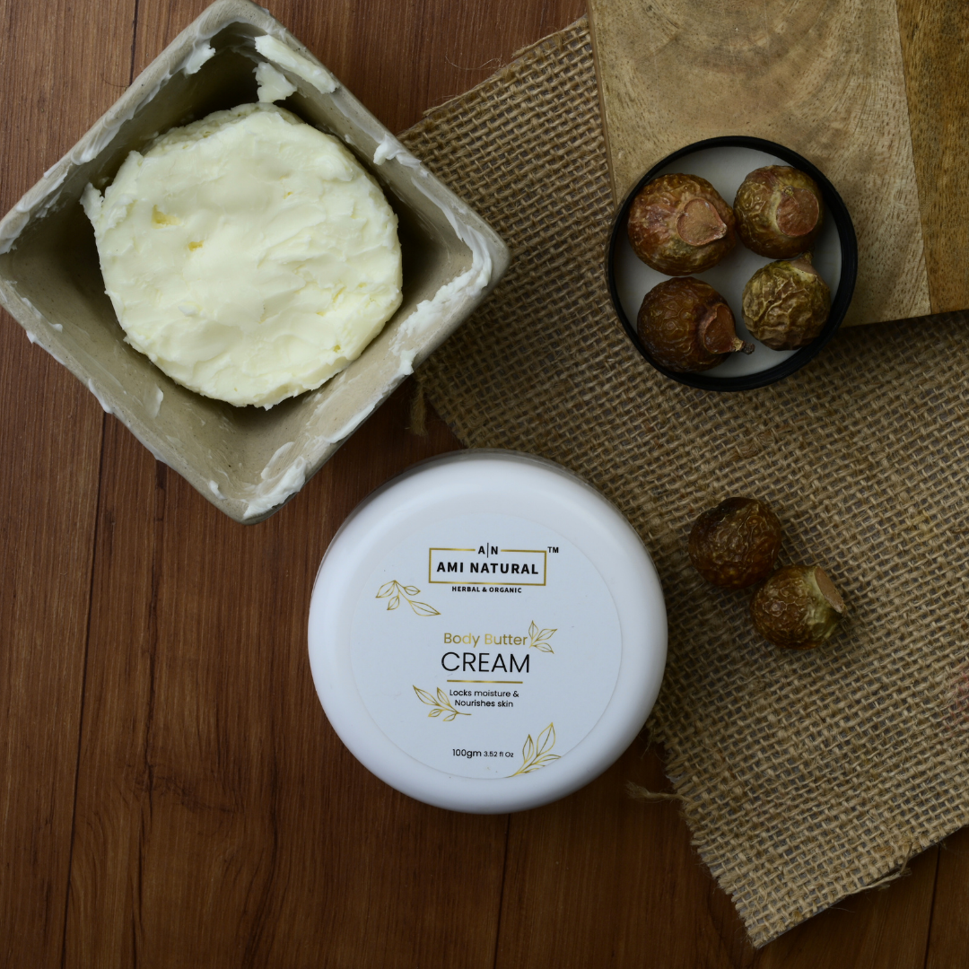 Ami Natural Shea & Cocoa body butter cream in white jar with cream texture in container and shea nuts on burlap cloth for smooth skin